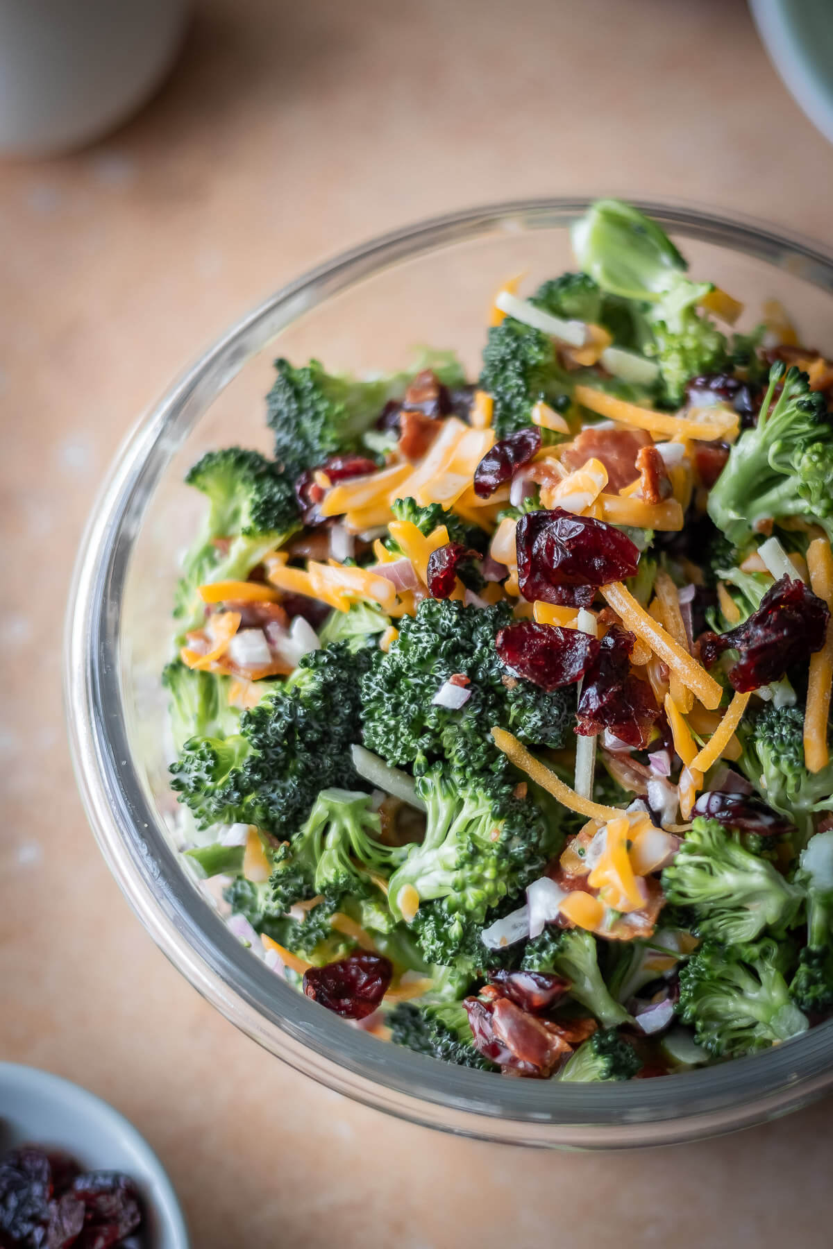 Close up of Raw Broccoli Salad with cheddar cheese, craisins, onions and bacon