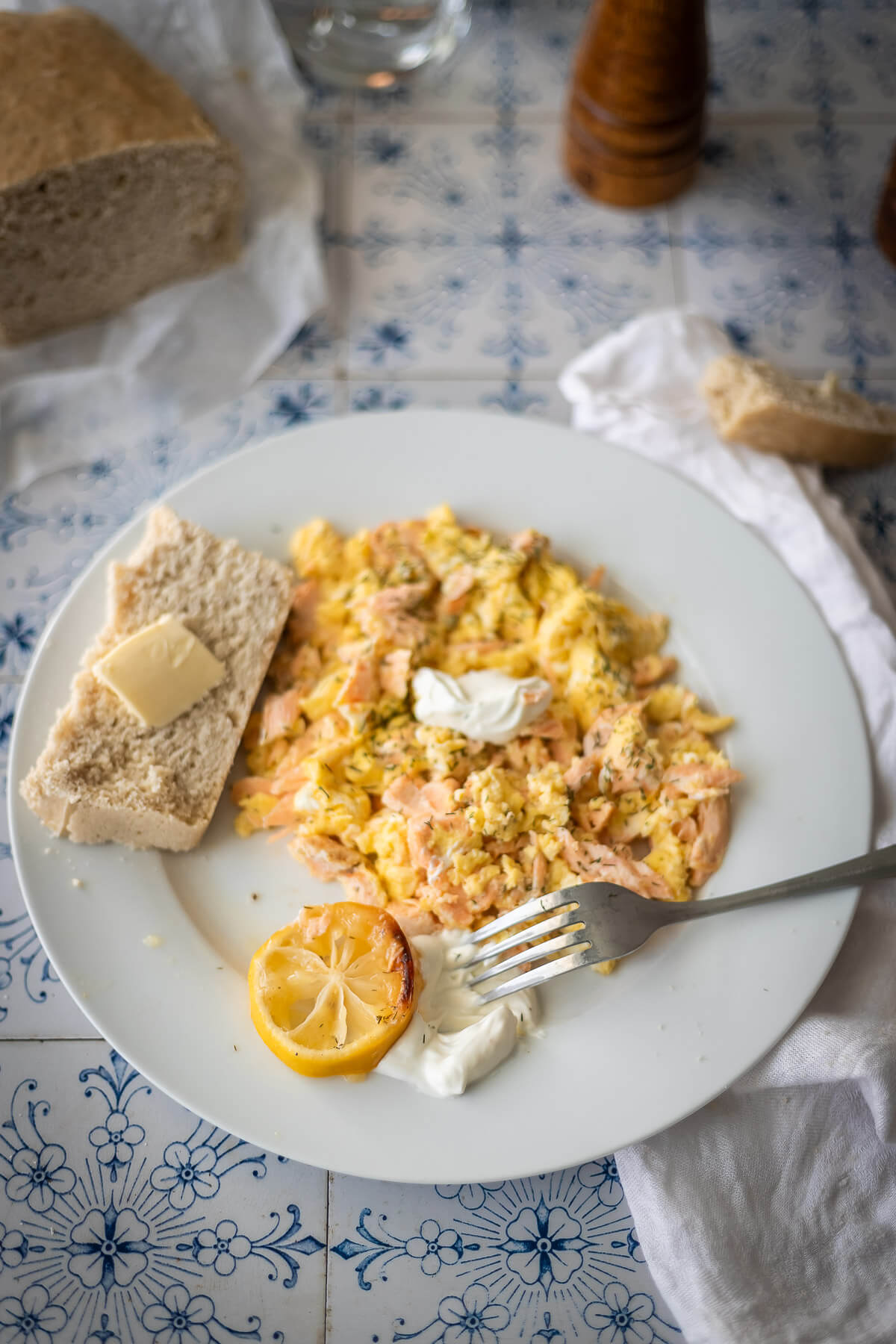 Salmon and Eggs on a plate with dill sauce and buttered bread