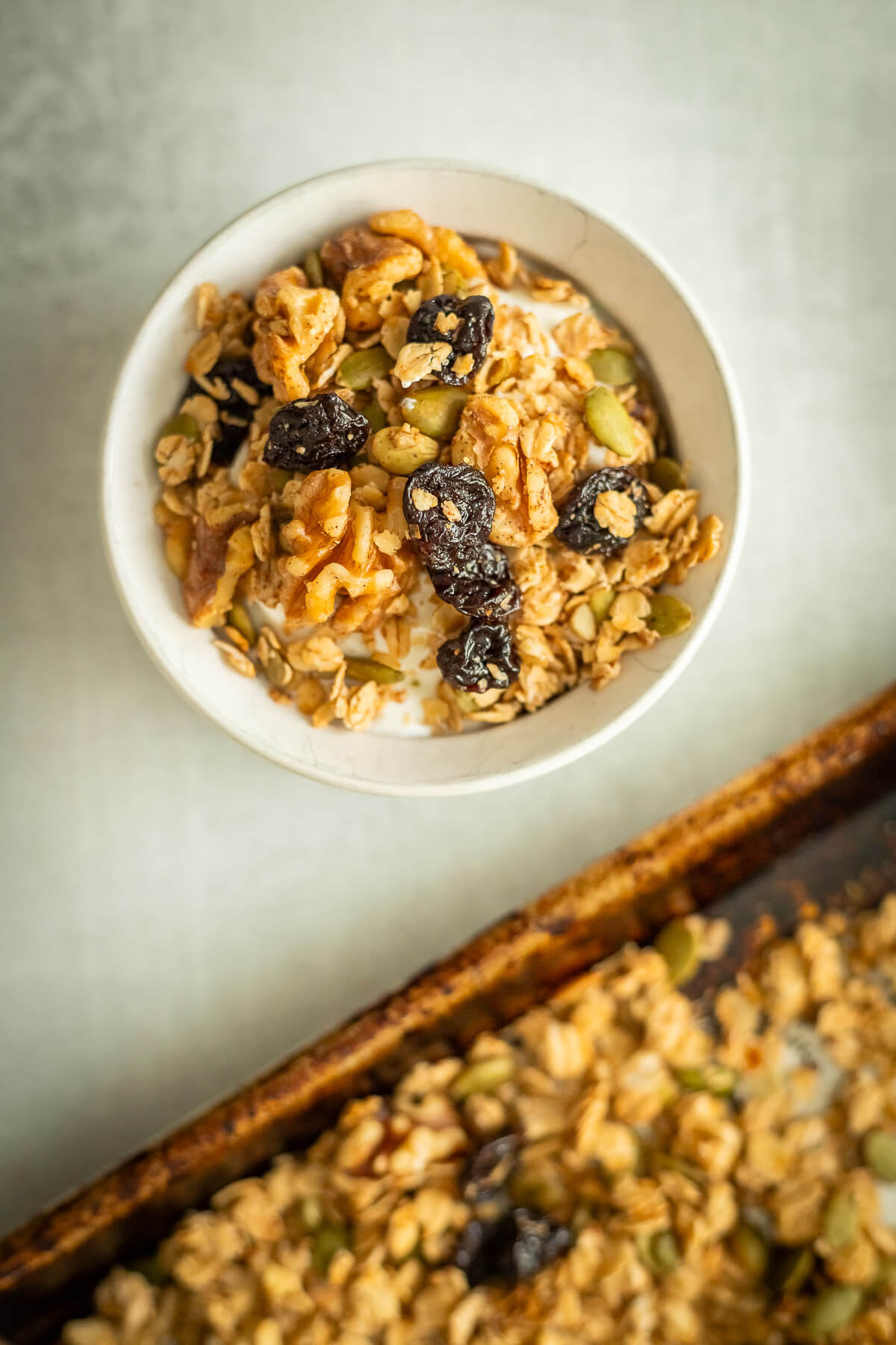 A bowl of homemade cherry walnut granola over yogurt.